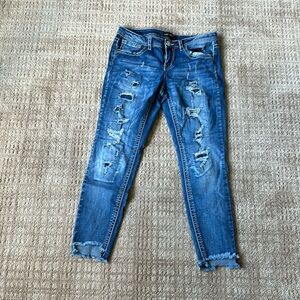 Dark blue ripped jeans (patches under the rips)